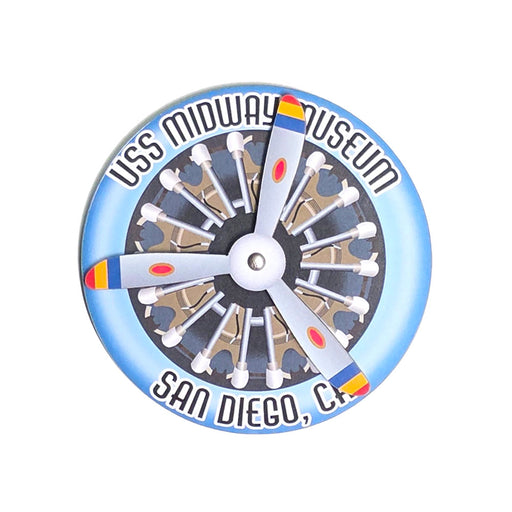 Show your love for aviation with the USS Midway Plane Spinner Magnet, featuring a round design with a blue border, a detailed propeller and engine illustration at its center, and the text “USS Midway Museum San Diego, CA.” This unique souvenir is perfect for collectors and enthusiasts looking to add an authentic USS Midway magnet or plane spinner magnet to their collection.