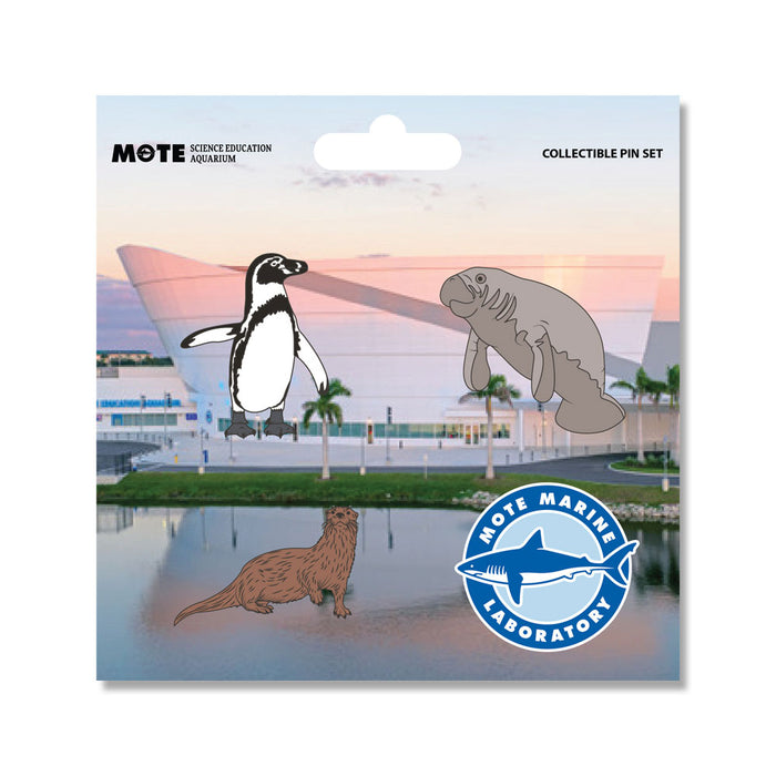 The Mote Marine Laboratory Pin Set features three adorable animal pins—penguin, manatee, and otter—along with a blue Mote Marine Laboratory logo pin, all presented on a card showcasing a modern aquarium building flanked by palm trees and water. This delightful set is an ideal gift for anyone who supports marine conservation and the vital efforts of Mote Marine Laboratory.
