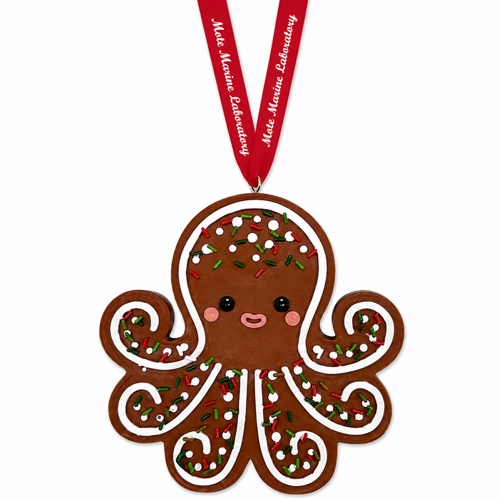 The Mote Marine Laboratory Gingerbread Octopus Ornament features a smiling octopus adorned with colorful sprinkles and hangs from a red ribbon inscribed with “Make Magic Laboratory,” offering a delightful tribute to marine conservation and the mission of Mote Marine Laboratory.