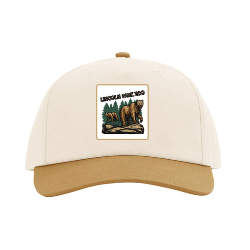 The Lincoln Park Zoo Brown Bear Scene Cap is a beige and tan baseball cap with a patch featuring two bears, trees, and the text “Lincoln Park Zoo” on the front—perfect for showing your support of wildlife conservation while coordinating with your favorite Lincoln Park Zoo tote.