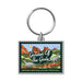 Garden of the Gods Colorado 150th Keychain featuring a rectangular design with an illustrated stamp motif that depicts red rock formations, dinosaurs, and lush greenery—a tribute to the iconic Colorado landmark. The keychain displays the text “Garden of the Gods” and “Sesquisesquiquincentennial,” marking a special 150th anniversary celebration. A silver keyring is attached at the top.