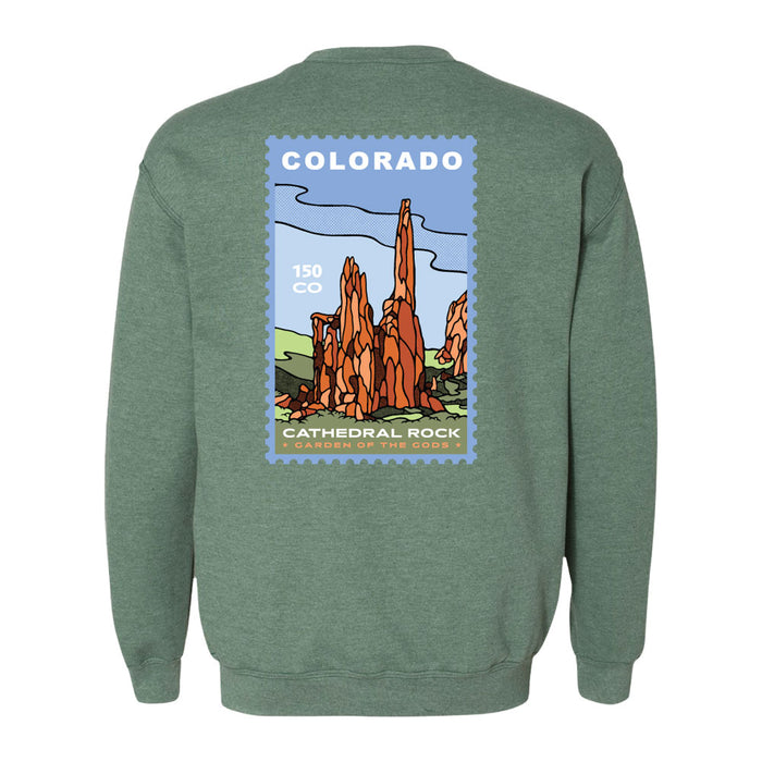 A green Garden of the Gods Colorado 150th Anniversary Sweatshirt featuring a graphic on the back of stylized red rock formations labeled “Colorado Cathedral Rock - Garden of the Gods,” framed by a blue postage stamp-like border.