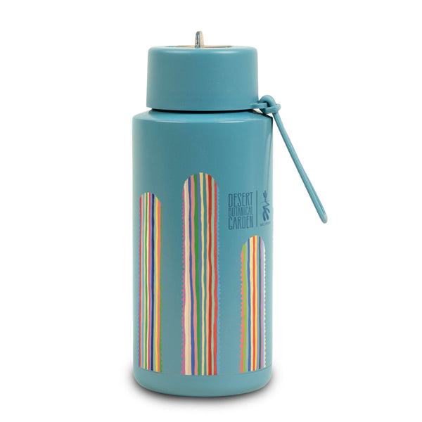 The Desert Botanical Garden Will Beger Colorful Cactus Water Bottle is a blue stainless steel bottle featuring vertical, multicolored stripe designs and “Desert Botanical Garden” text on the side, complete with a matching blue handle attached to the lid—perfect for anyone who loves a vibrant cactus water bottle.