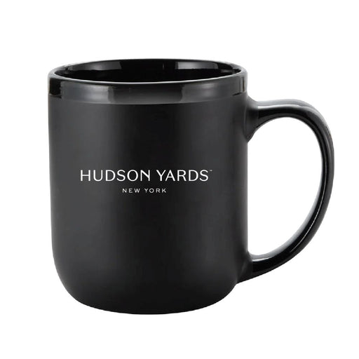 A black ceramic Edge NYC Octane Mug, featuring “HUDSON YARDS NEW YORK” printed in white on the front and inspired by the iconic New York skyline mug, is displayed on a white background.