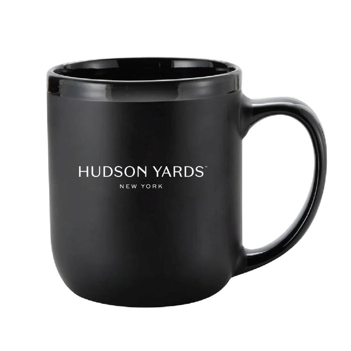 A black ceramic Edge NYC Octane Mug, featuring “HUDSON YARDS NEW YORK” printed in white on the front and inspired by the iconic New York skyline mug, is displayed on a white background.