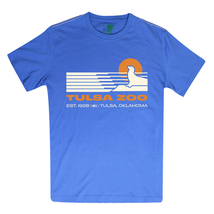 The Tulsa Zoo Sea Lion Sporty Pop T-Shirt is made from organic cotton and features a white and orange sea lion on sunset waves with “Tulsa Zoo, Est. 1928 Tulsa, Oklahoma.” Ethically produced for lasting comfort and sporty style.