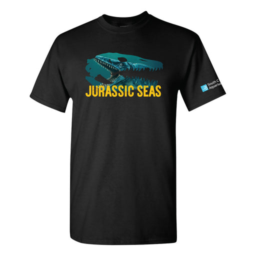 Black t-shirt featuring a large teal dinosaur skull above the yellow text “JURASSIC SEAS”; South Carolina Aquarium logo is on the left sleeve.