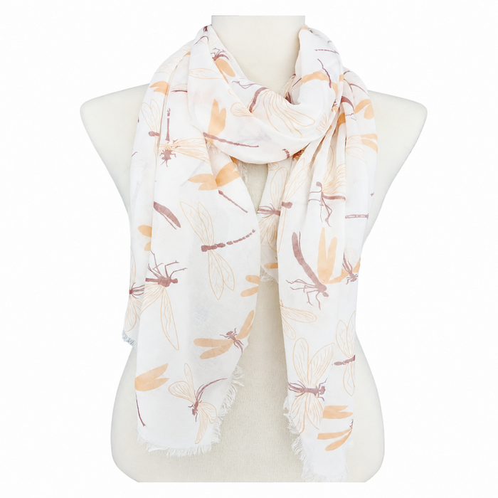 A white Dragonfly Scarf featuring light orange dragonfly prints is elegantly draped around a mannequin torso, with fringed edges visible at each end—capturing the delicate charm of botanical gardens and making it an ideal addition to any nature-inspired wardrobe.