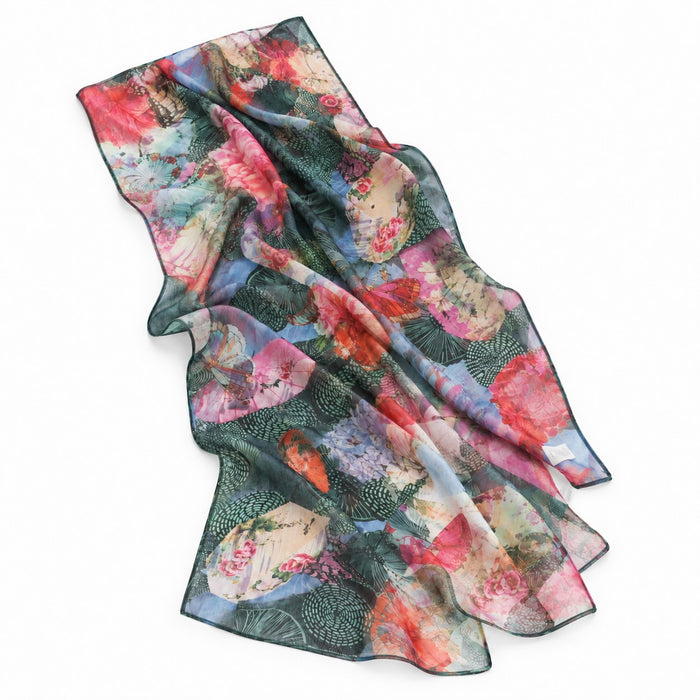 Introducing the Textured Butterfly Scarf—a sheer, rectangular silk accessory adorned with a vibrant butterfly-inspired pattern in shades of pink, red, green, and blue on a crisp white background. This eco-friendly scarf is crafted to bring both elegance and sustainability to any ensemble.