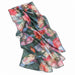 Introducing the Textured Butterfly Scarf—a sheer, rectangular silk accessory adorned with a vibrant butterfly-inspired pattern in shades of pink, red, green, and blue on a crisp white background. This eco-friendly scarf is crafted to bring both elegance and sustainability to any ensemble.
