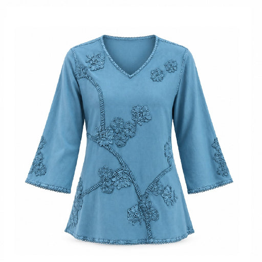 Teal Embroidered Women’s Top featuring a V-neck and intricate floral embroidery on the front, sleeves, and hem. Made from eco-friendly materials, this long-sleeve blouse embodies sustainable fashion with its soft, flowing look and decorative edge stitching.