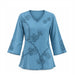 Teal Embroidered Women’s Top featuring a V-neck and intricate floral embroidery on the front, sleeves, and hem. Made from eco-friendly materials, this long-sleeve blouse embodies sustainable fashion with its soft, flowing look and decorative edge stitching.