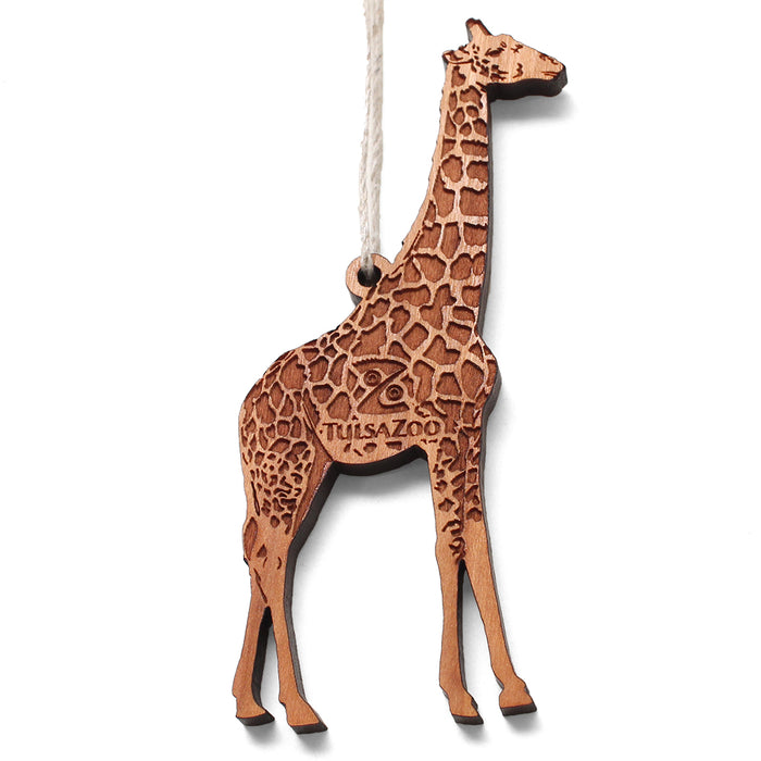 The Tulsa Zoo Giraffe Wooden Ornament features engraved spots, "Tulsa Zoo" on its side, and includes a top string for easy hanging—a charming wooden keepsake for any space.