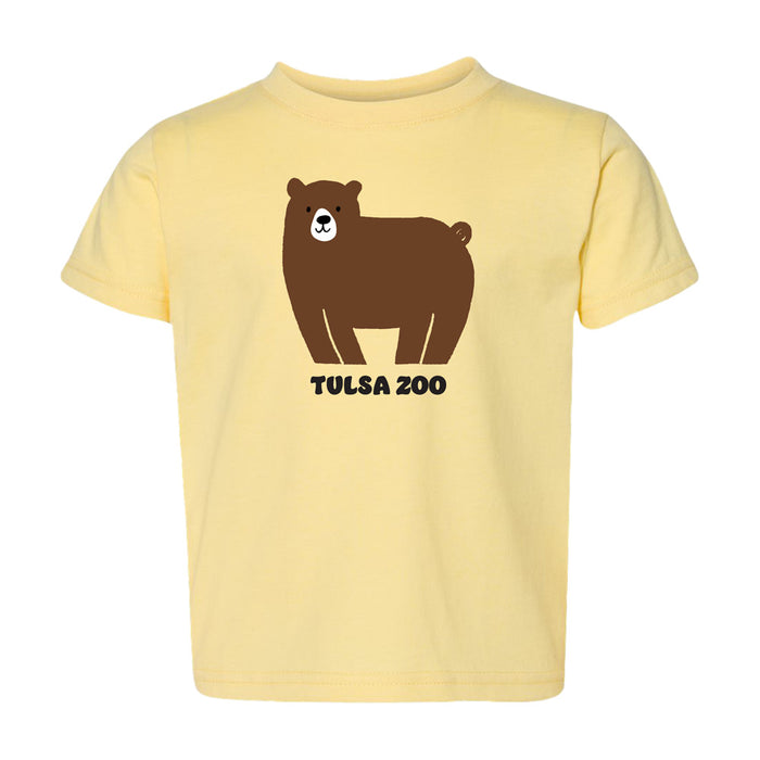 The Tulsa Zoo Bear Toddler T-Shirt is a light yellow tee with a cute cartoon brown bear above the words "Tulsa Zoo" in bold black letters.