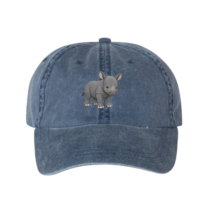 The Lincoln Park Zoo Embroidered Baby Rhino Cap is a blue denim cap featuring an embroidered gray baby rhinoceros on the front, inspired by Lincoln Park Zoo’s commitment to wildlife conservation.