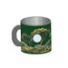 The Tulsa Zoo Giraffe Mini Mug Magnet is a green mug with a handle, decorated with trees and greenery inspired by wildlife conservation, and features a white circular spot on its side.