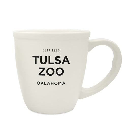The Tulsa Zoo Est 1928 Bistro Mug is a white ceramic mug featuring "ESTD 1928 TULSA ZOO OKLAHOMA" in bold black letters, ideal for wildlife conservation fans.