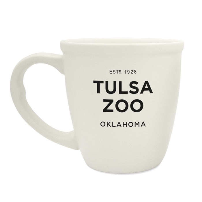 The Tulsa Zoo Est 1928 Bistro Mug is a white ceramic mug with black "ESTD 1928 TULSA ZOO OKLAHOMA" text—perfect for wildlife conservation supporters and Tulsa Zoo fans.