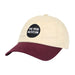 Introducing The Mob Museum Two-Tone Dad Cap: a beige dad cap featuring a maroon brim and a black circle patch on the front with white “THE MOB MUSEUM” text—an essential accessory for any fan.
