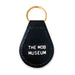 The Mob Museum Teardrop Key Fob is a black leather keychain with a gold keyring, featuring “THE MOB MUSEUM” in bold white capital letters on the front—a sleek souvenir from Las Vegas.
