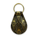 The Mob Museum Teardrop Key Fob features a striking Art Deco pattern in gold set against a black teardrop background, finished with a gold-colored keyring at the top—an elegant accessory that captures the glamorous spirit of Las Vegas and serves as an ideal keepsake for fans of the Mob Museum.