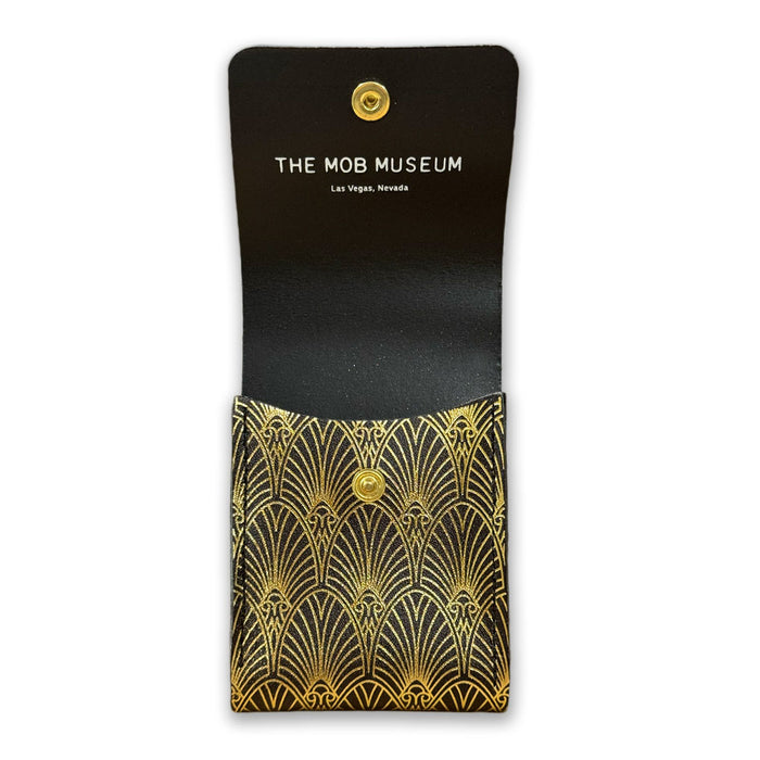 The Mob Museum Playing Card Holder—a black case adorned with gold art deco patterns—opens to reveal “THE MOB MUSEUM Las Vegas, Nevada” printed inside the flap, offering a stylish tribute to organized crime history.