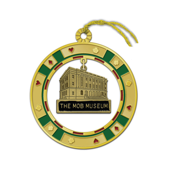 Introducing The Mob Museum Poker Chip Metal Ornament—a gold ornament designed in the shape of a poker chip, adorned with red and green accents and featuring an illustration of The Mob Museum building at its center. Complete with a gold hanging string, this distinctive Las Vegas ornament makes the perfect casino-inspired keepsake for enthusiasts of gaming history and the city’s legendary attractions.