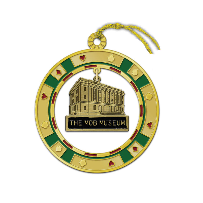 Introducing The Mob Museum Poker Chip Metal Ornament—a gold ornament designed in the shape of a poker chip, adorned with red and green accents and featuring an illustration of The Mob Museum building at its center. Complete with a gold hanging string, this distinctive Las Vegas ornament makes the perfect casino-inspired keepsake for enthusiasts of gaming history and the city’s legendary attractions.