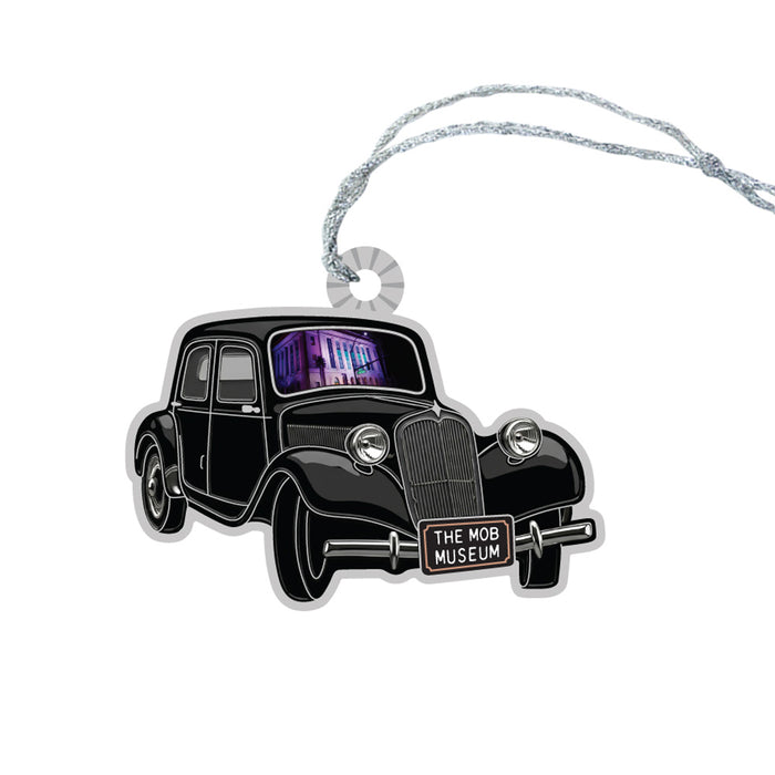 The Mob Museum Car Ornament is a vintage black car-shaped ornament featuring “The Mob Museum” on the license plate and a hanging string. A small image of Las Vegas’ iconic Mob Museum building appears in the windows of the car, making this ornament a unique tribute to the city’s organized crime history.