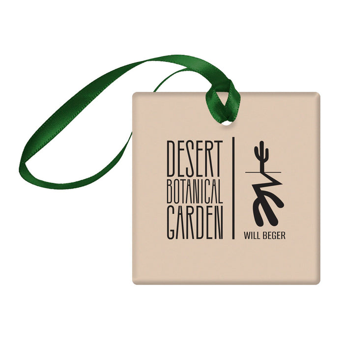 Square tan Desert Botanical Garden Will Beger Ornament with a green ribbon hanger, featuring the text Desert Botanical Garden and Will Beger next to a stylized cactus graphic.