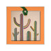 Desert Botanical Garden Will Beger Ornament: a square desert landscape keepsake with an orange border and a cutout of three vertically striped saguaro cacti, suspended by a green ribbon.