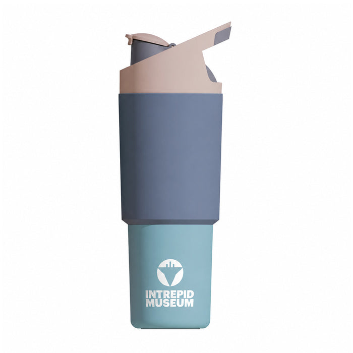 The Intrepid Museum Colorblock Waterbottle features a blue and gray design, a flip-top lid, and the Intrepid Museum logo printed on the lower section.