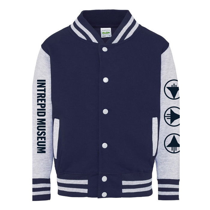 The Intrepid Museum Icons Youth Bomber Jacket features a navy and gray design with “INTREPID MUSEUM” in blue on the left sleeve and three circular aviation history icons on the right sleeve. Classic white stripes accent the collar, cuffs, and hem for an iconic Intrepid Museum bomber jacket style.