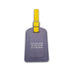 A purple Ford’s Theatre Come from Away luggage tag featuring a yellow strap with a silver buckle. The front of the tag displays “YOU ARE HERE, AT THE START OF A MOMENT” in white text, inspired by the Tony Award-winning musical.