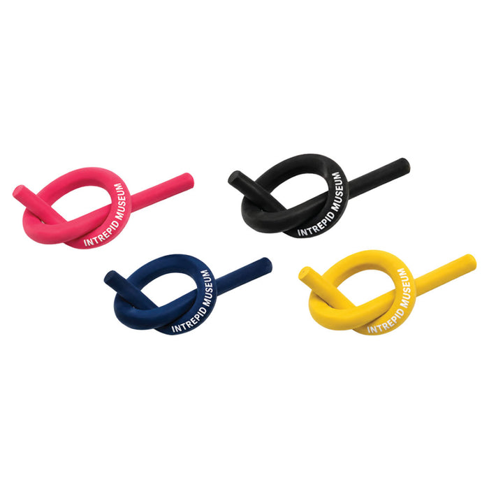 Four Intrepid Museum Bendy Erasers, each twisted into a knot and colored pink, black, blue, and yellow, display “Intrepid Museum” on their surface. Perfect as a unique aircraft carrier souvenir or naval aviation gift, these erasers—each featuring an Intrepid Museum label—are arranged in two rows on a white background.