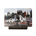 A variety of jet aircraft are showcased outdoors on a platform at the Intrepid Museum, set against the backdrop of towering city skyscrapers and a clear sky—an ideal view for aviation enthusiasts or as featured on the Intrepid Museum Planes Photo Magnet.