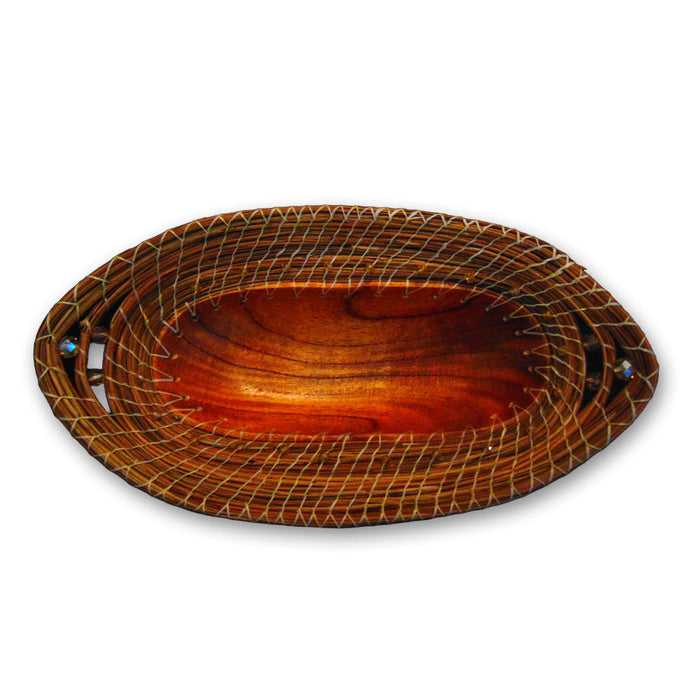 The Large Pine Needle Oval Basket is a handcrafted decorative piece featuring an oval shape, rich brown finish, and white threads artistically woven around the rim. Viewed from above against a white background, this basket evokes the artistry of traditional pine needle baskets—blending elegant style with sustainable home decor for an eco-friendly accent to any space.