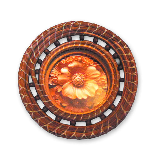 The Pine Needle Flower Basket is a round decorative wall hanging featuring a carved flower design at its center, encircled by a woven, circular wooden frame. With rich shades of brown and orange, it brings a perfect rustic touch to your home decor.