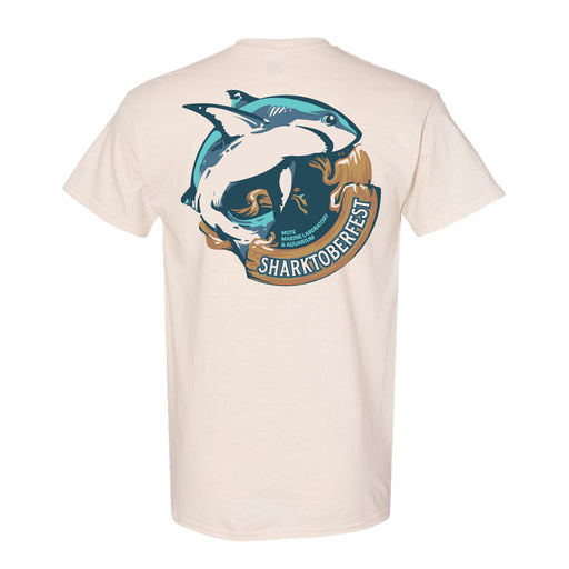 Show your support for marine life conservation with the official Mote Marine Laboratory Sharktober Fest T-Shirt. This beige T-shirt features a graphic of a shark leaping over waves and rocks, with “Sharktoberfest” printed below the image.