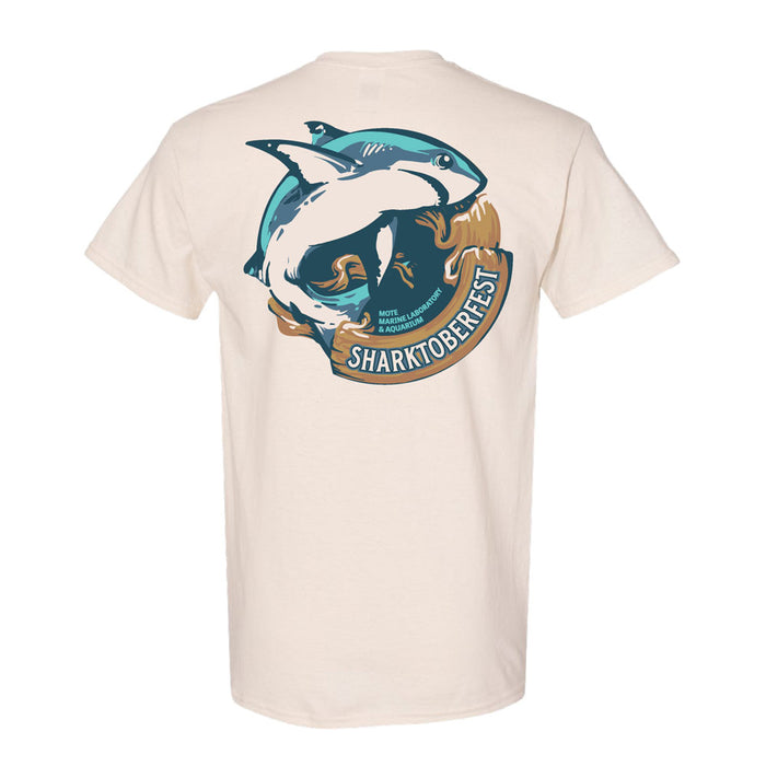 Show your support for marine life conservation with the official Mote Marine Laboratory Sharktober Fest T-Shirt. This beige T-shirt features a graphic of a shark leaping over waves and rocks, with “Sharktoberfest” printed below the image.