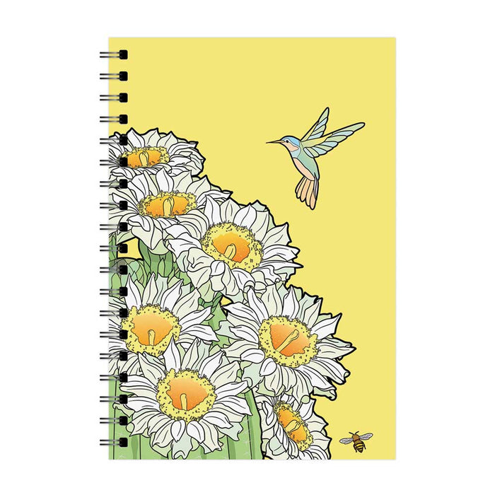 Desert Botanical Garden Superbloom Spiral Notebook with a yellow cover featuring illustrations of white cactus flowers, a hummingbird, and a bee.