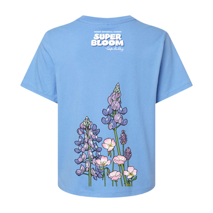 Light blue Desert Botanical Garden Superbloom Women’s Cropped T-Shirt featuring a back print of purple lupine and pink wildflowers with the garden’s name printed above.