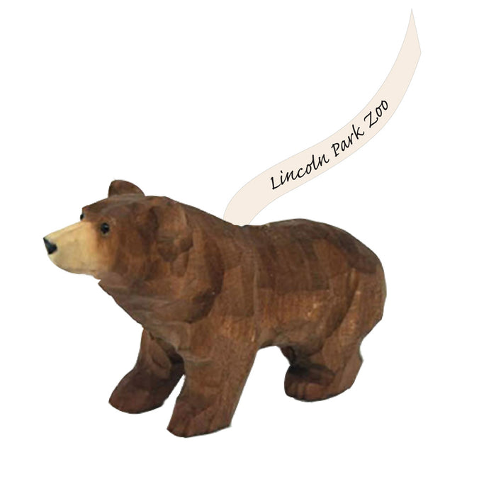 The Lincoln Park Zoo Bear Ornament features a wooden bear standing on all fours, with a curved banner above its back that reads “Lincoln Park Zoo”—a tribute to wildlife conservation.