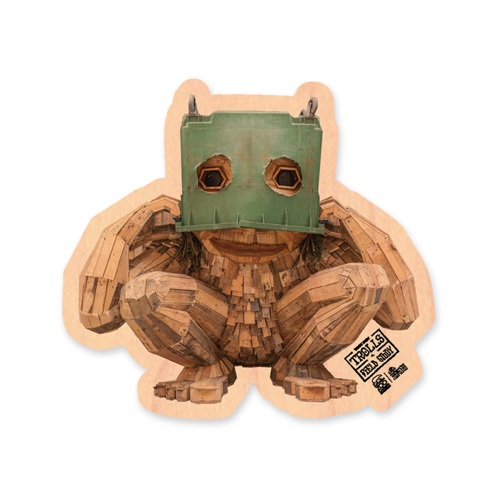 A Thomas Dambo, Trolls Field Study Magnet featuring a wooden sculpture of a crouching troll wearing a green box over its head, with the text Trolls Field Study printed in the corner.