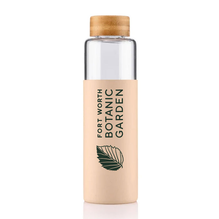 Fort Worth Botanical Garden Sleeved Glass Bottle made of clear glass with a wooden cap and a tan silicone sleeve featuring a green leaf icon and branding.