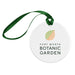 Round white Fort Worth Botanical Garden Ornament with a green and orange leaf graphic, hanging from a green ribbon loop as a Texas garden keepsake.