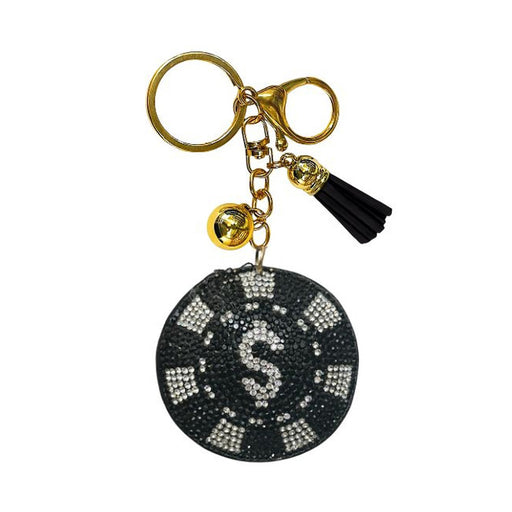 The Bling Poker Chip Bag Charm features a gold keychain adorned with a black and white rhinestone poker chip charm, a small gold bell, and a black tassel, all attached to a gold keyring and clasp. It’s the perfect poker accessory or card game gift for any enthusiast.