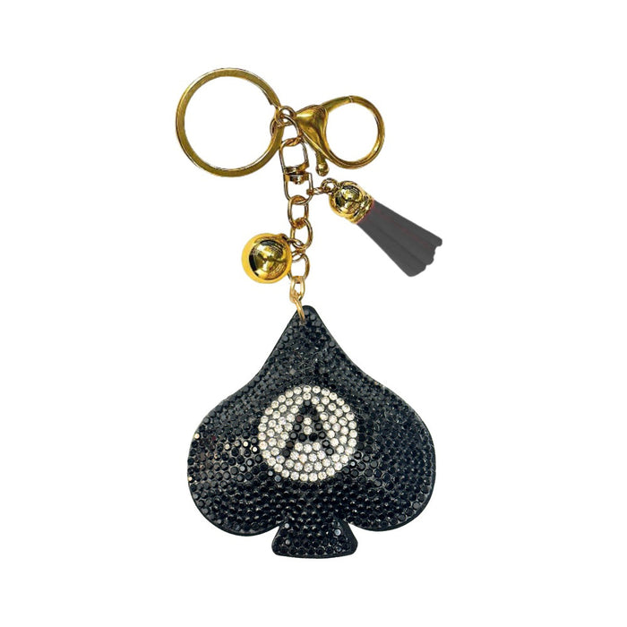 Introducing the Bling Ace of Spades Bag Charm—a gold keychain adorned with a sparkling black spade-shaped charm encrusted in rhinestones, a circle of white rhinestones featuring a bold letter A at its center, a gleaming gold bell, and a chic black tassel. This luxury bag accessory is the perfect way to add an elegant touch to any handbag while making a dazzling statement. Elevate your collection with this eye-catching Ace of Spades fashion bag charm!.