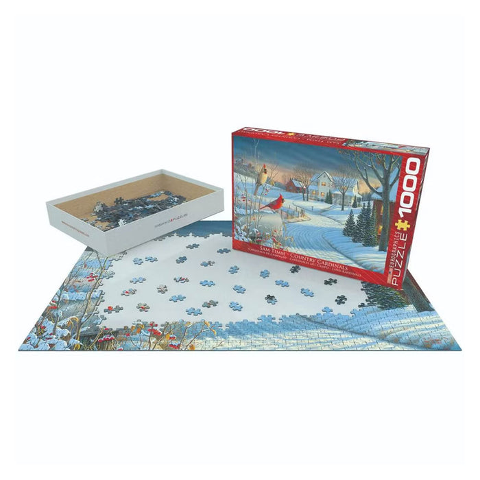 A 1000-piece Country Cardinals puzzle in progress, featuring a winter scene of birds in a snowy landscape, shown with its box and a tray of loose pieces.