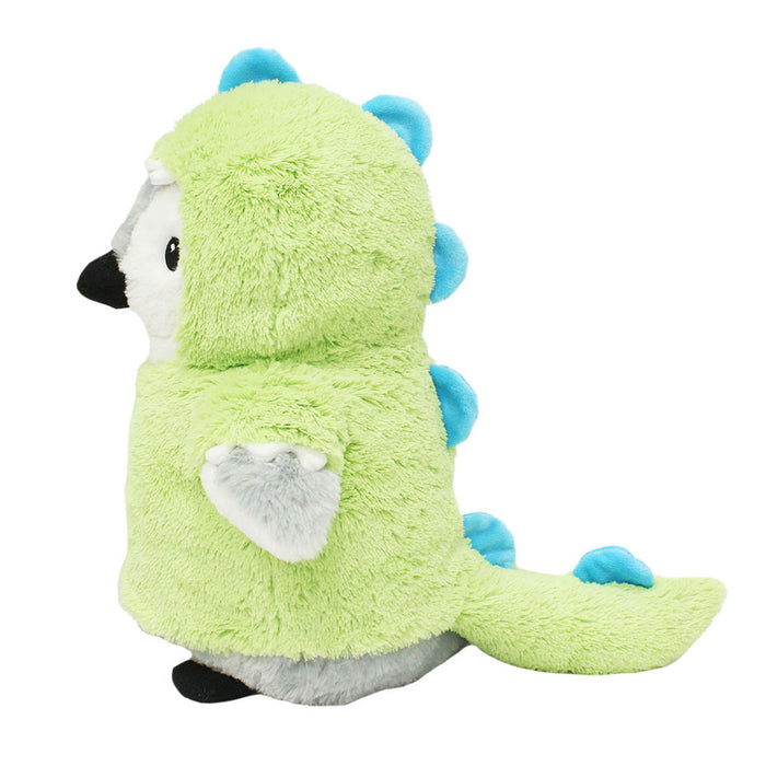 A 12" plush penguin wears the eco-friendly Plushy's Closet Dino Costume—fuzzy light green with blue spikes—facing left on a white background.